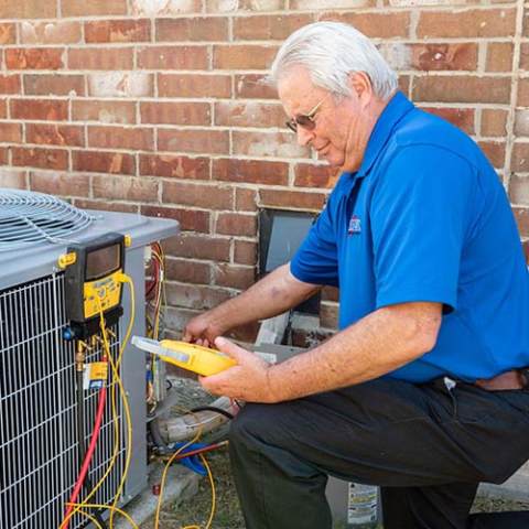 Steve Sherrell inspects a customer's HVAC unit